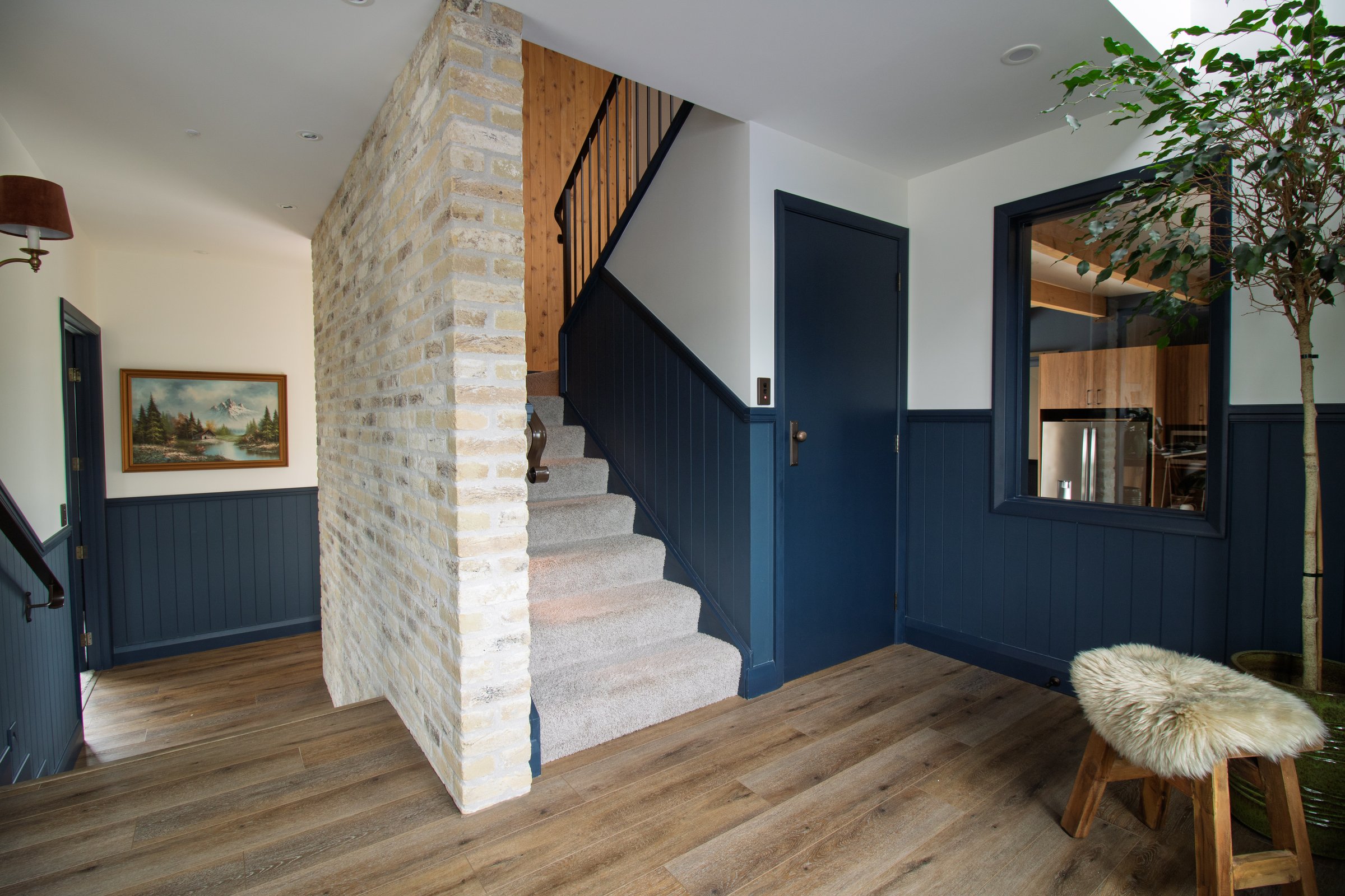 Internal Belgian brick wall and timber staircase beside the entry void