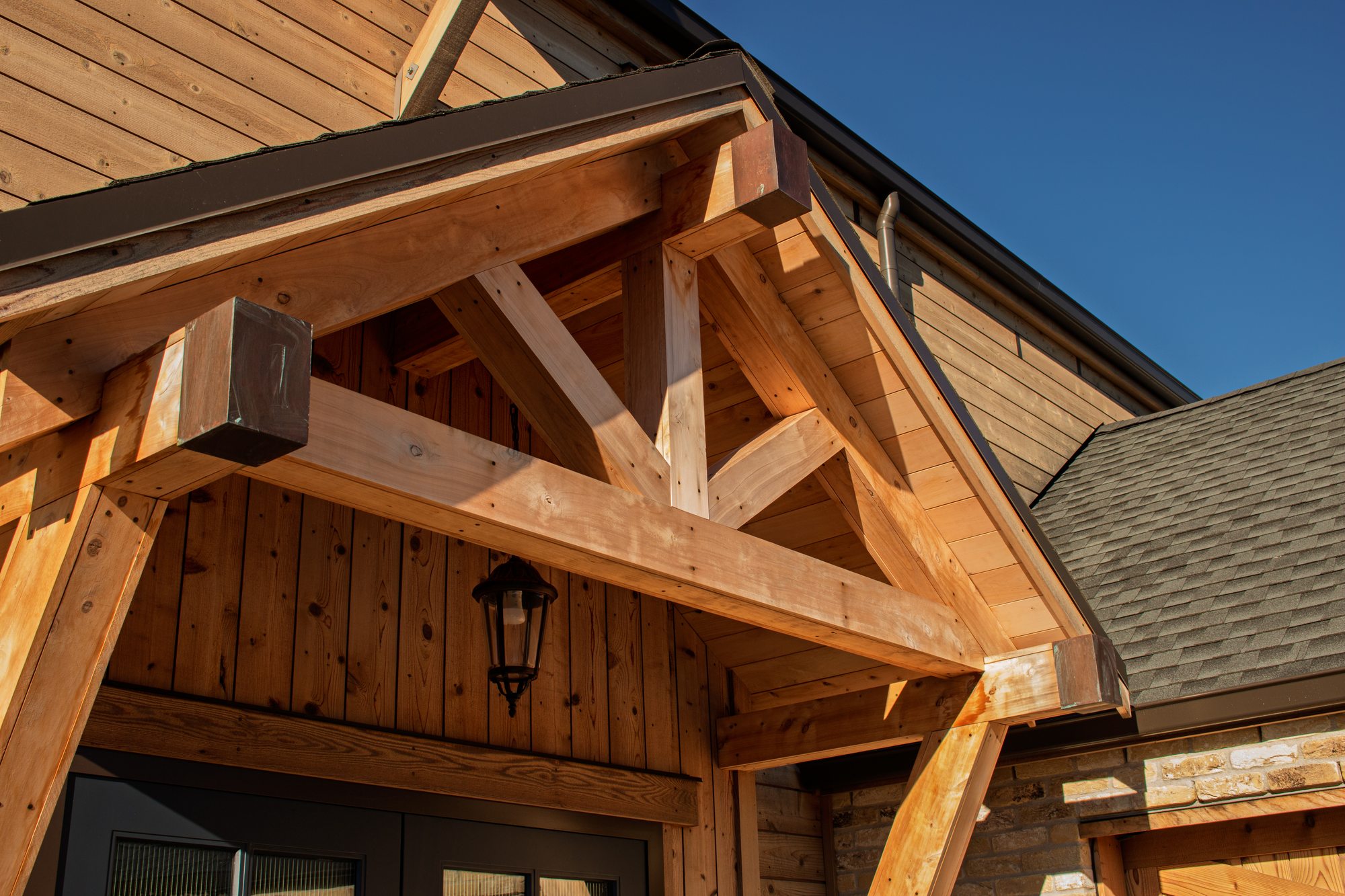 Exposed timber truss and gable detail above the front entry