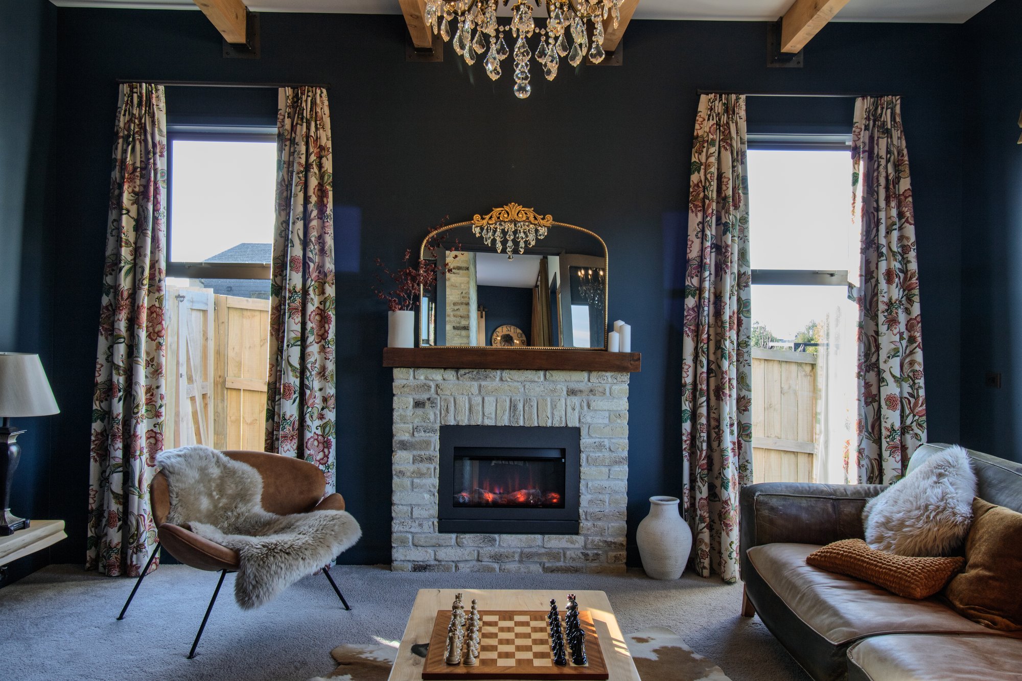 Separate lounge with Belgian brick fireplace surround and exposed timber rafters